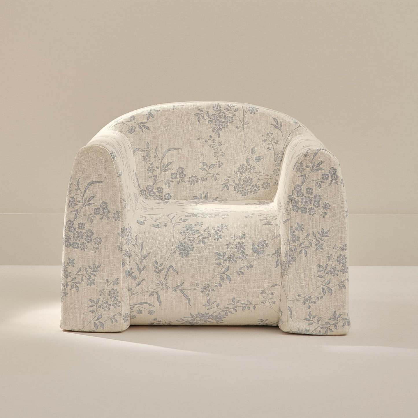 Floral-patterned armchair on a beige background