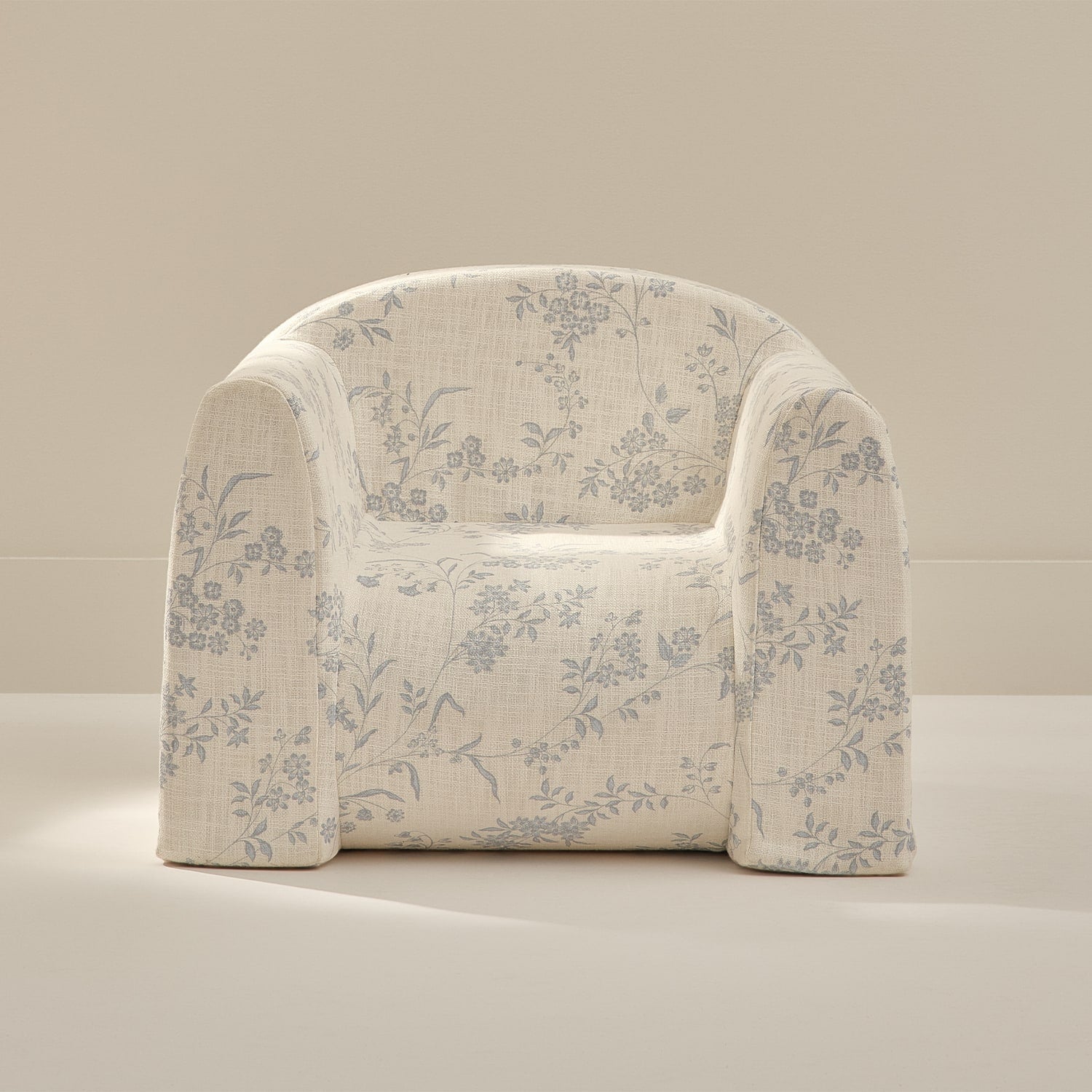 Floral-patterned armchair on a beige background