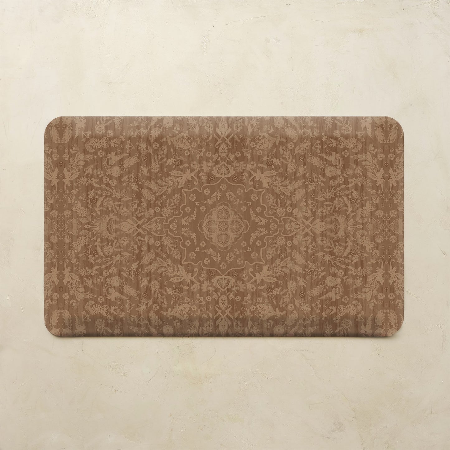 A rectangular kitchen mat with rounded corners featuring an intricate brown damask pattern, displayed flat against a textured beige background.