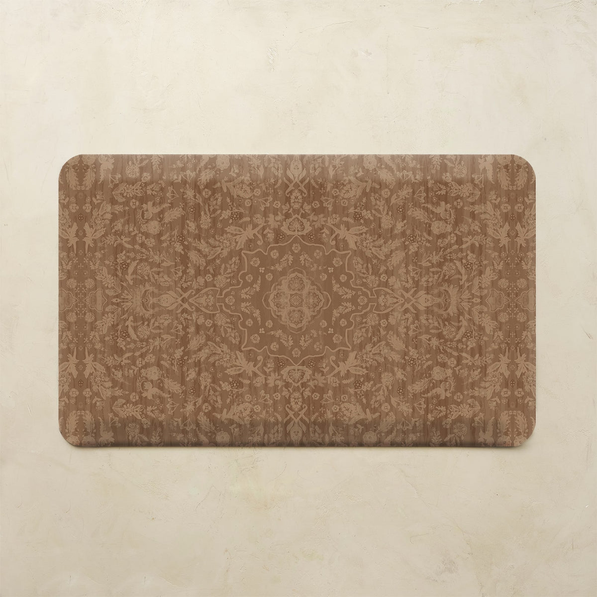 A rectangular kitchen mat with rounded corners featuring an intricate brown damask pattern, displayed flat against a textured beige background.