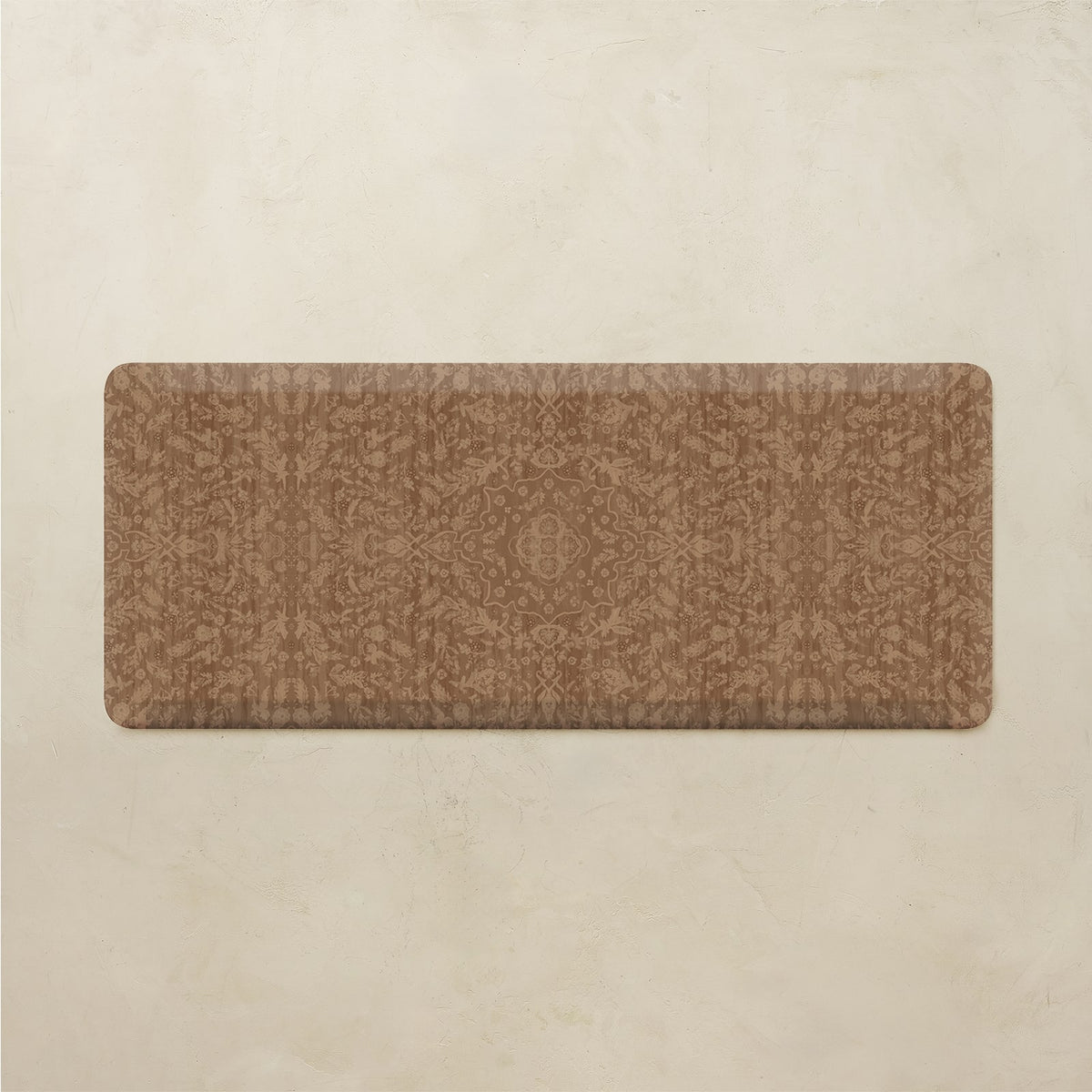 A rectangular brown kitchen rug with a subtle tonal damask pattern, displayed flat against a textured beige background.
