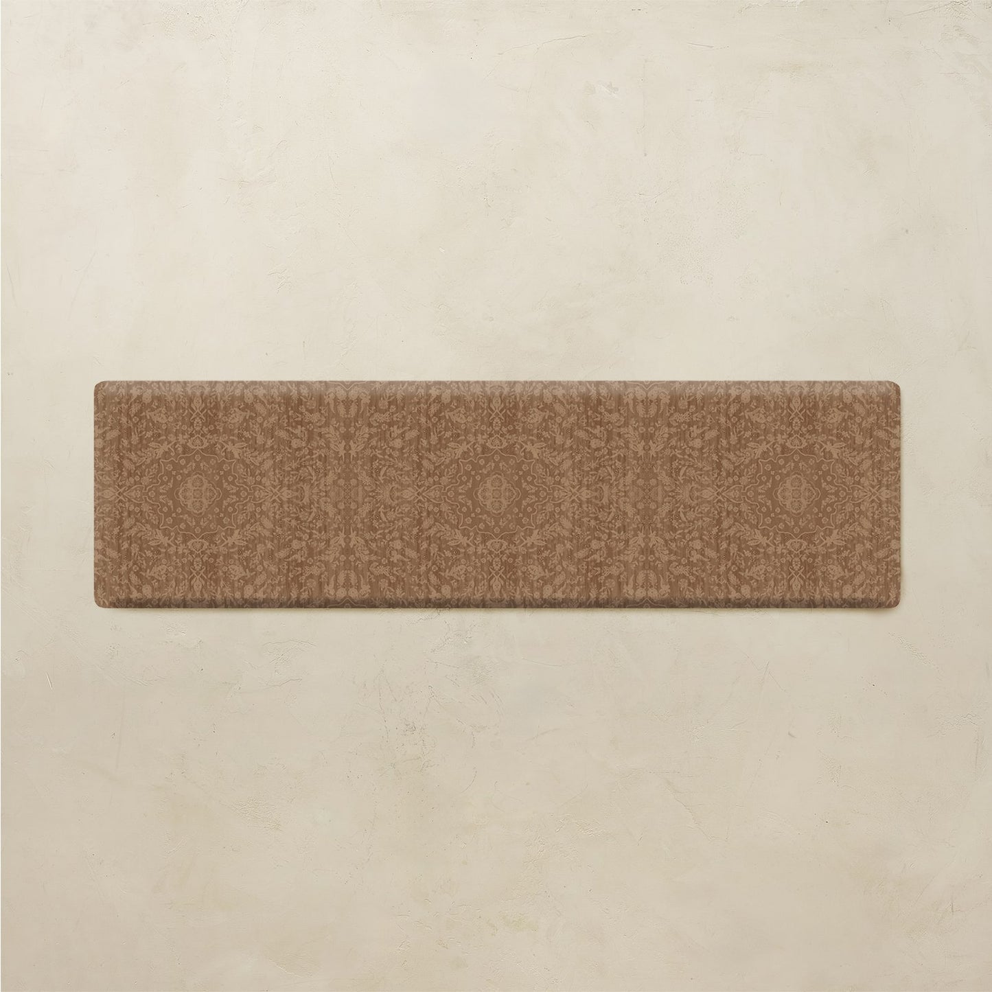 A rectangular brown runner rug with a subtle geometric medallion pattern, displayed flat against a textured beige background.