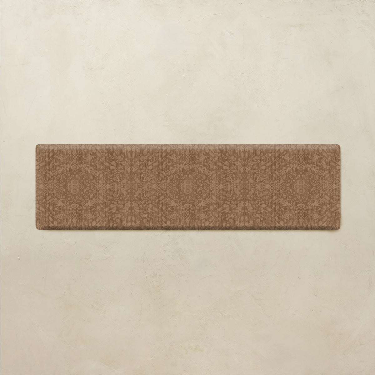 A rectangular brown runner rug with a subtle geometric medallion pattern, displayed flat against a textured beige background.