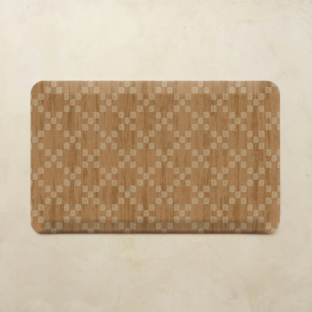 A rectangular mat with rounded corners featuring a woven wood grain pattern in warm brown and beige tones, displayed on a textured beige background.