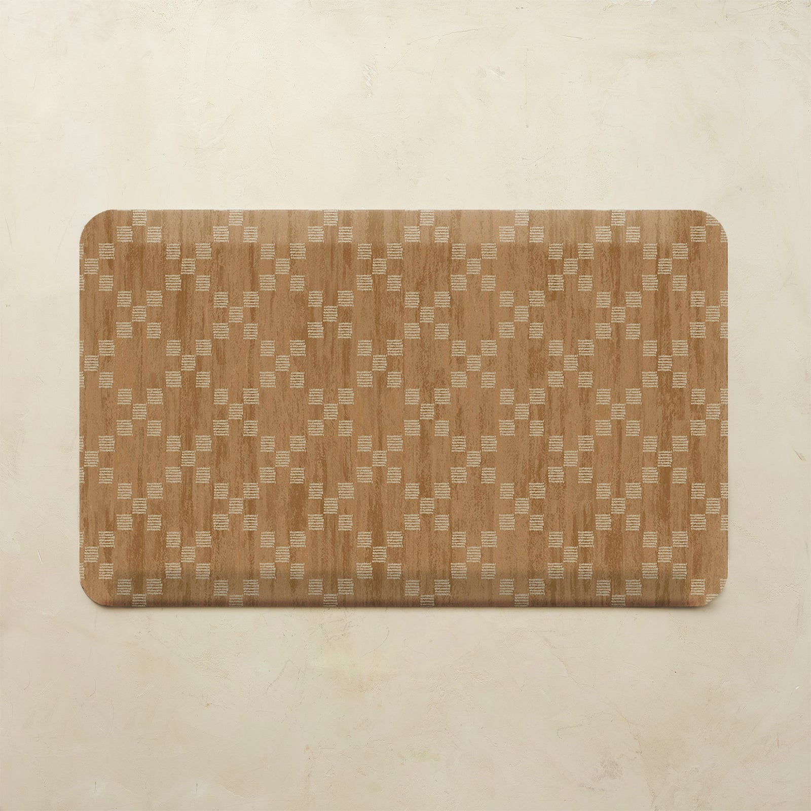 A rectangular mat with rounded corners featuring a woven wood grain pattern in warm brown and beige tones, displayed on a textured beige background.