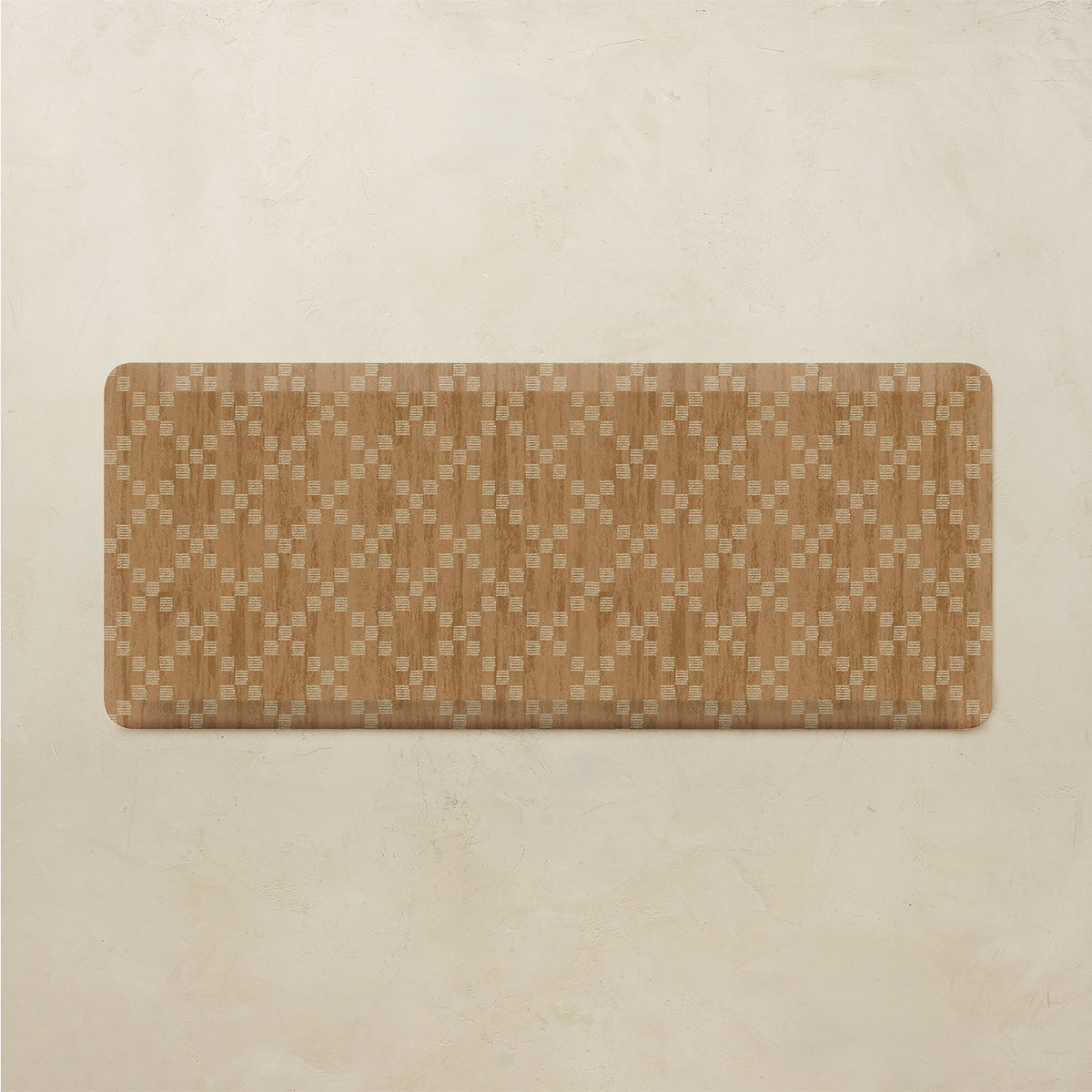A rectangular floor mat with rounded corners, featuring a woven geometric pattern in shades of brown and beige, displayed on a textured beige background.