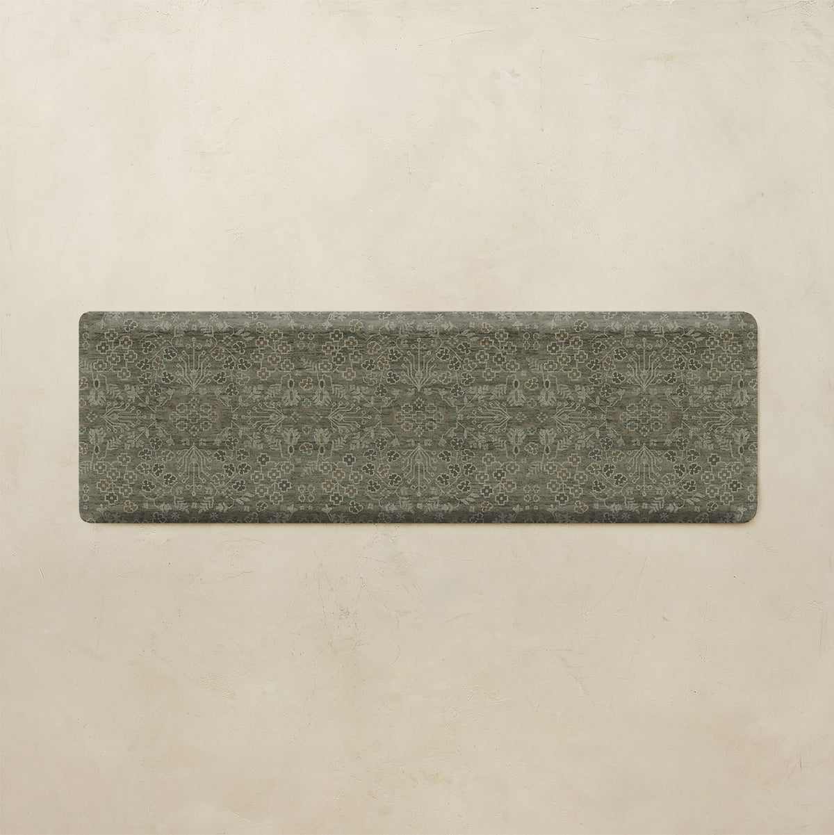 A rectangular yoga mat with a dark brown and black floral pattern, displayed flat against a textured beige background.