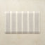 Rectangular kitchen mat with neutral striped pattern on a beige background