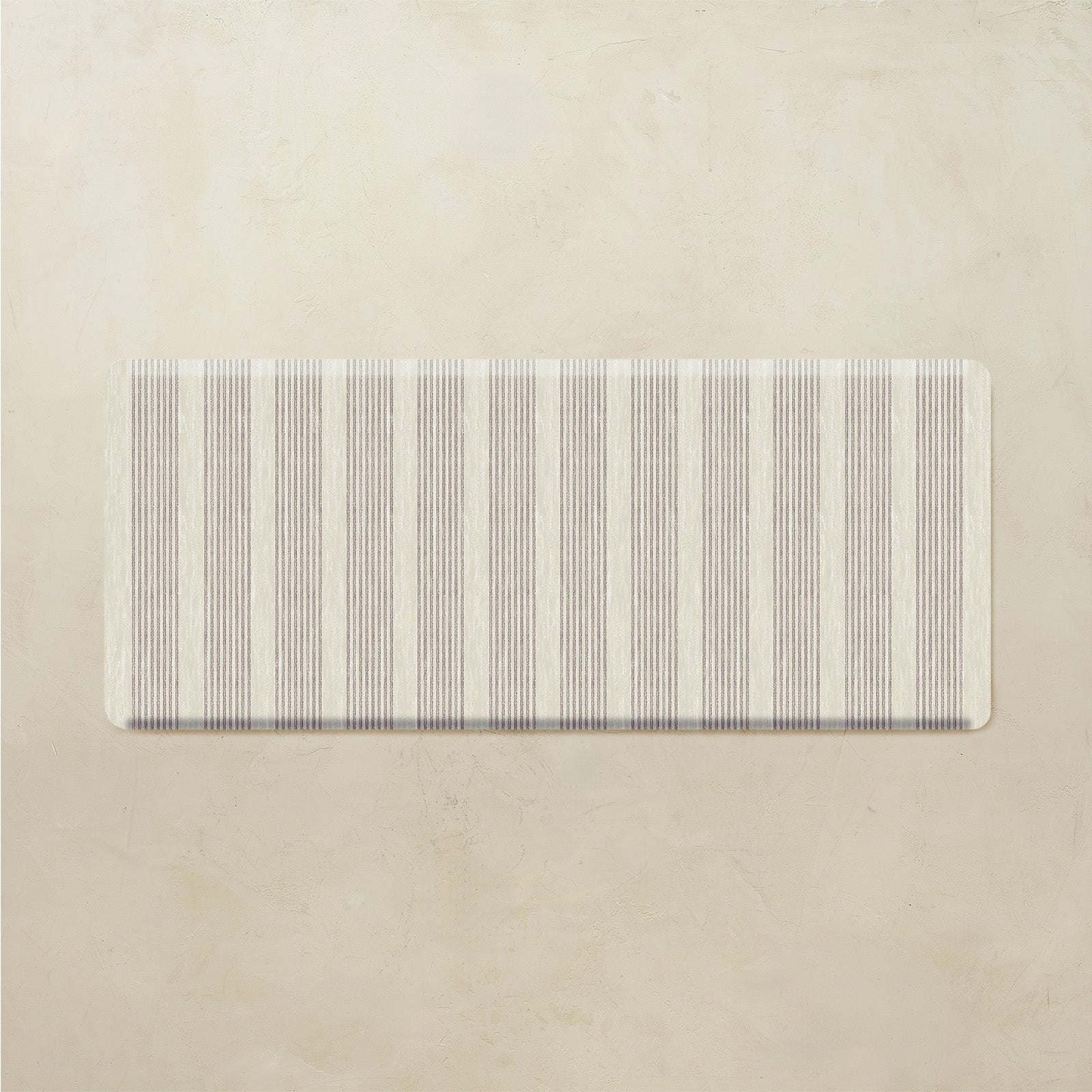 Rectangular mat with neutral striped pattern on a beige background