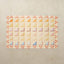 Sylvia Kaleidoscope 4x6 tumbling mat with quilt-inspired orange, pink, green and blue triangles and a red tulip border on a cream base