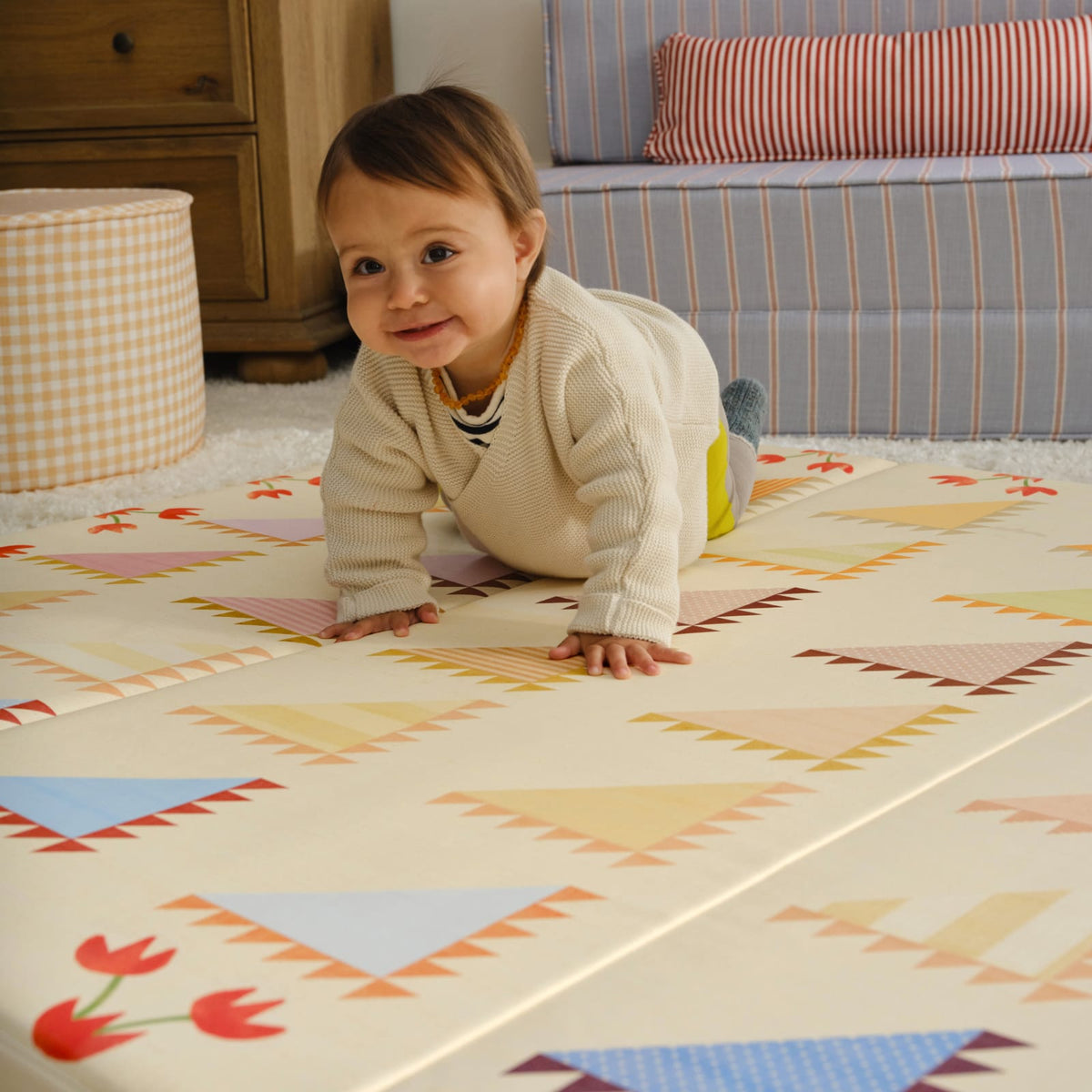Baby crawling on the quilt-inspired Sylvia Kaleidoscope tumbling mat