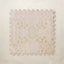 A square interlocking foam play mat tile with a faded blush and cream floral medallion pattern, shown from above on a light beige background.