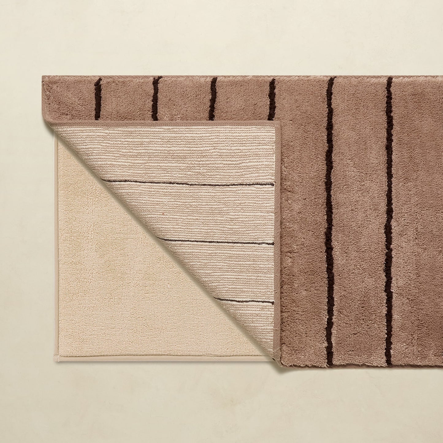 Two rugs with different patterns on a beige background