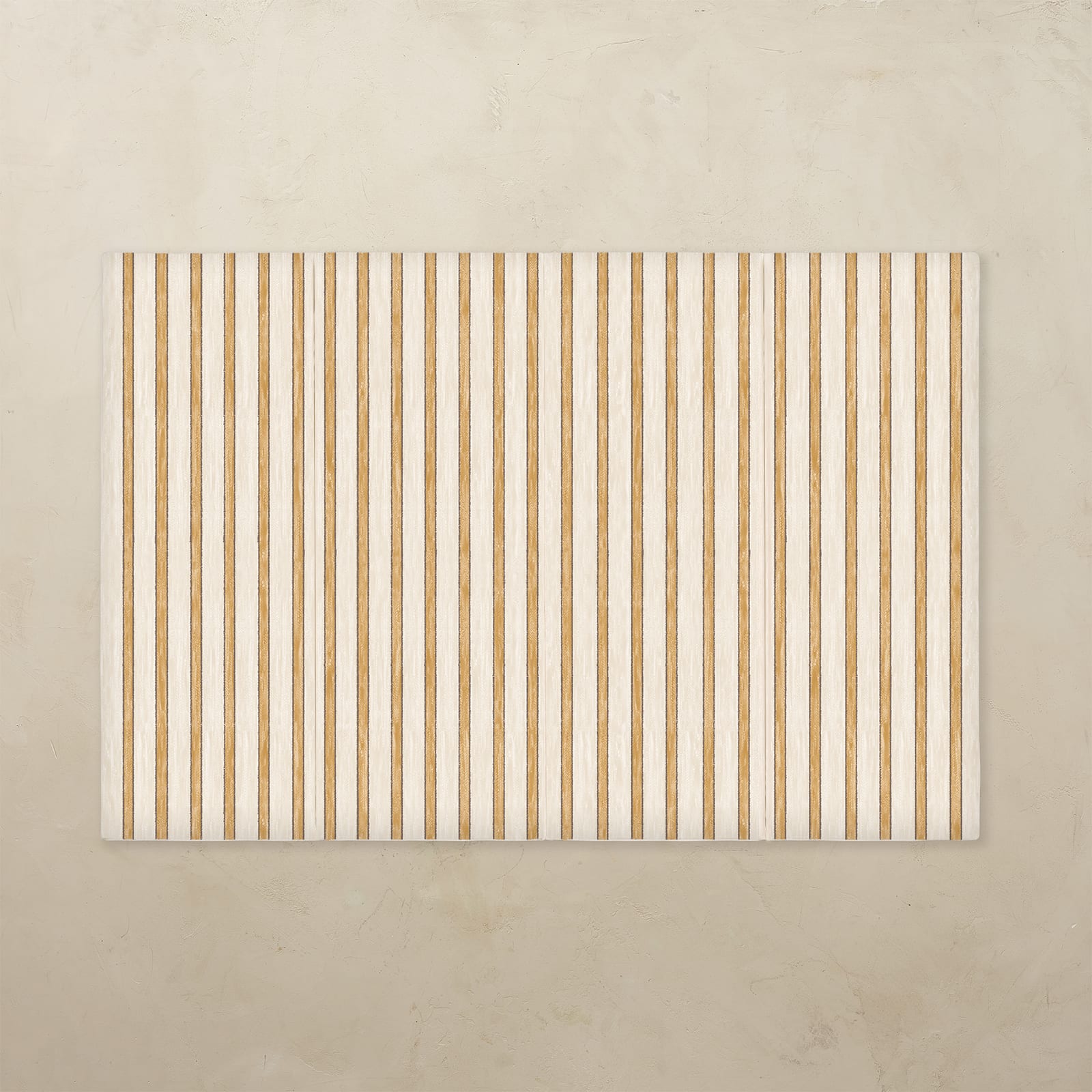 Rectangular area rug with vertical beige stripes on a beige background