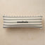 Striped pillow with 'anastasia' embroidery on a beige background