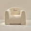 Beige textured armchair with 'Nora' embroidered on a beige background