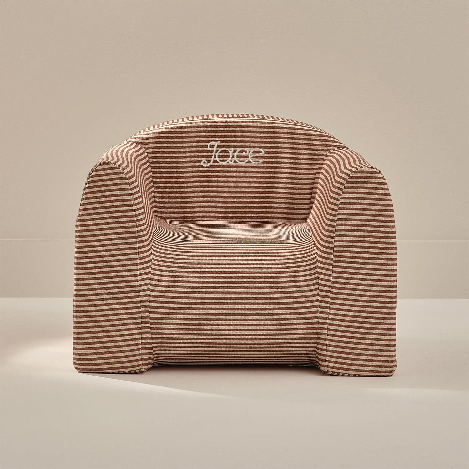 Striped chair with 'Jace' branding on a beige background