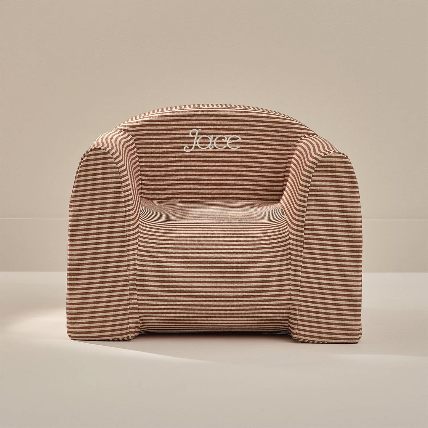 Striped chair with 'Jace' branding on a beige background