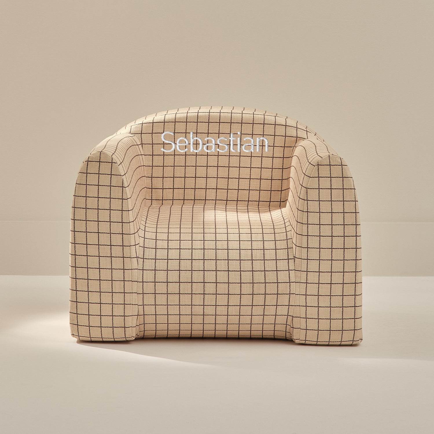 Beige checkered chair with 'Sebastian' branding on a beige background