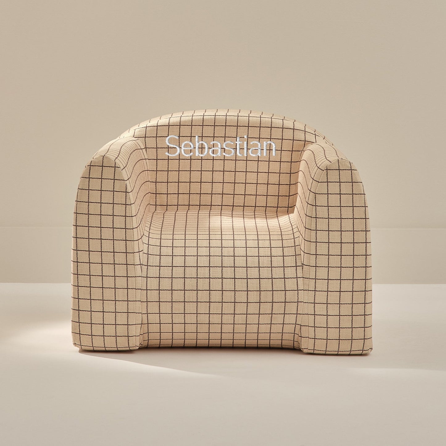 Beige checkered chair with 'Sebastian' branding on a beige background
