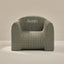 Green checkered armchair with 'Kevin' embroidered on a beige background