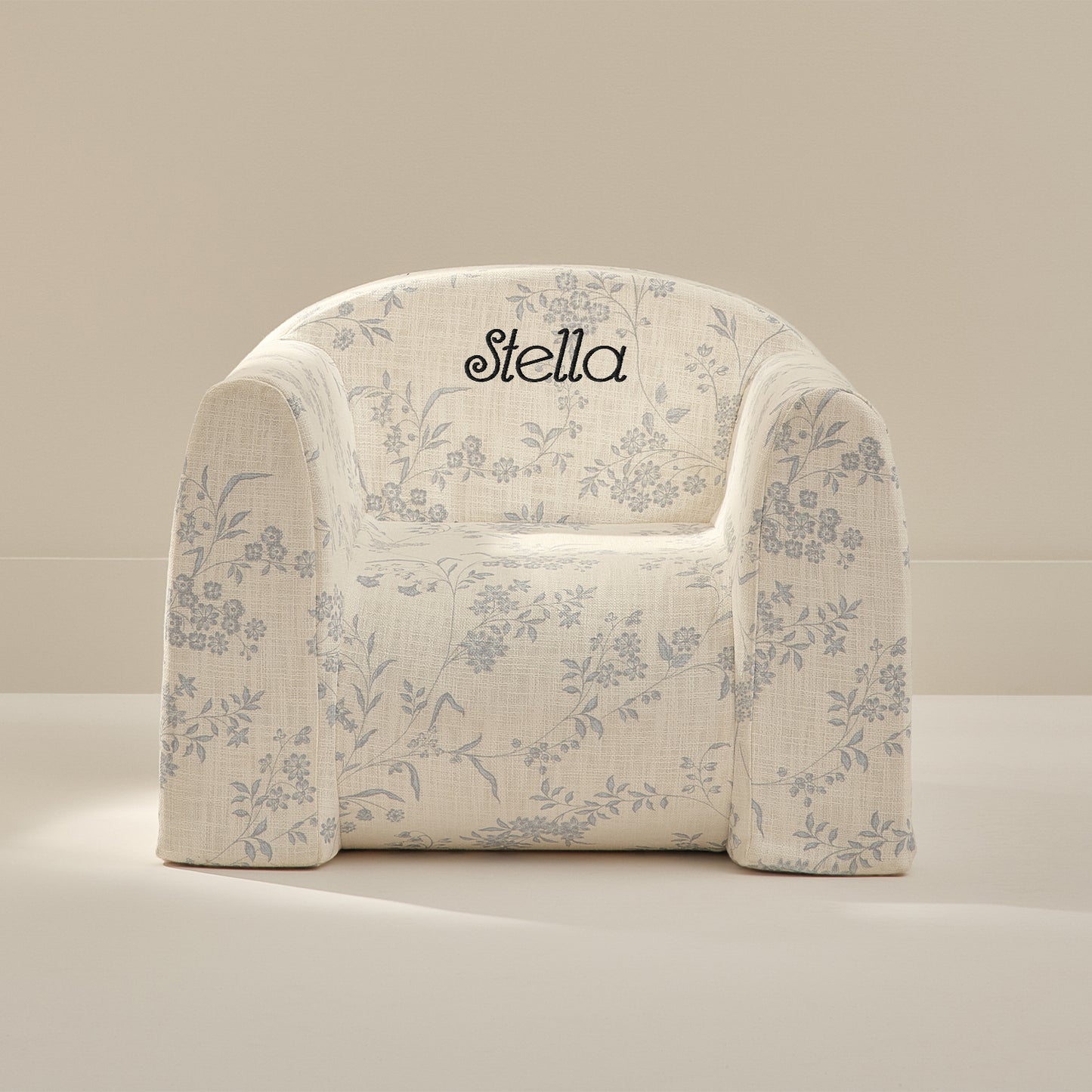 Floral-patterned chair with 'Stella' branding on a beige background