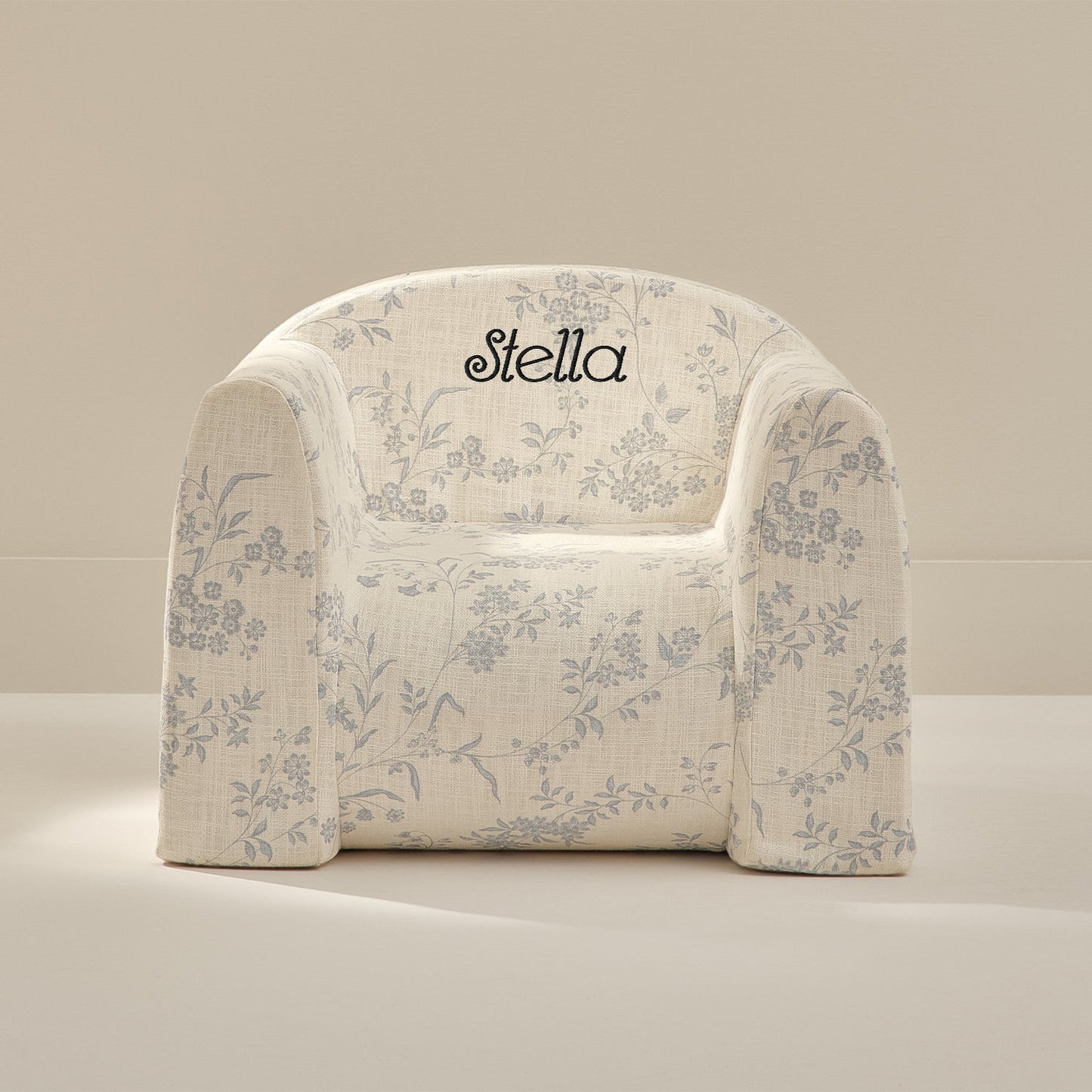 Floral-patterned chair with 'Stella' branding on a beige background
