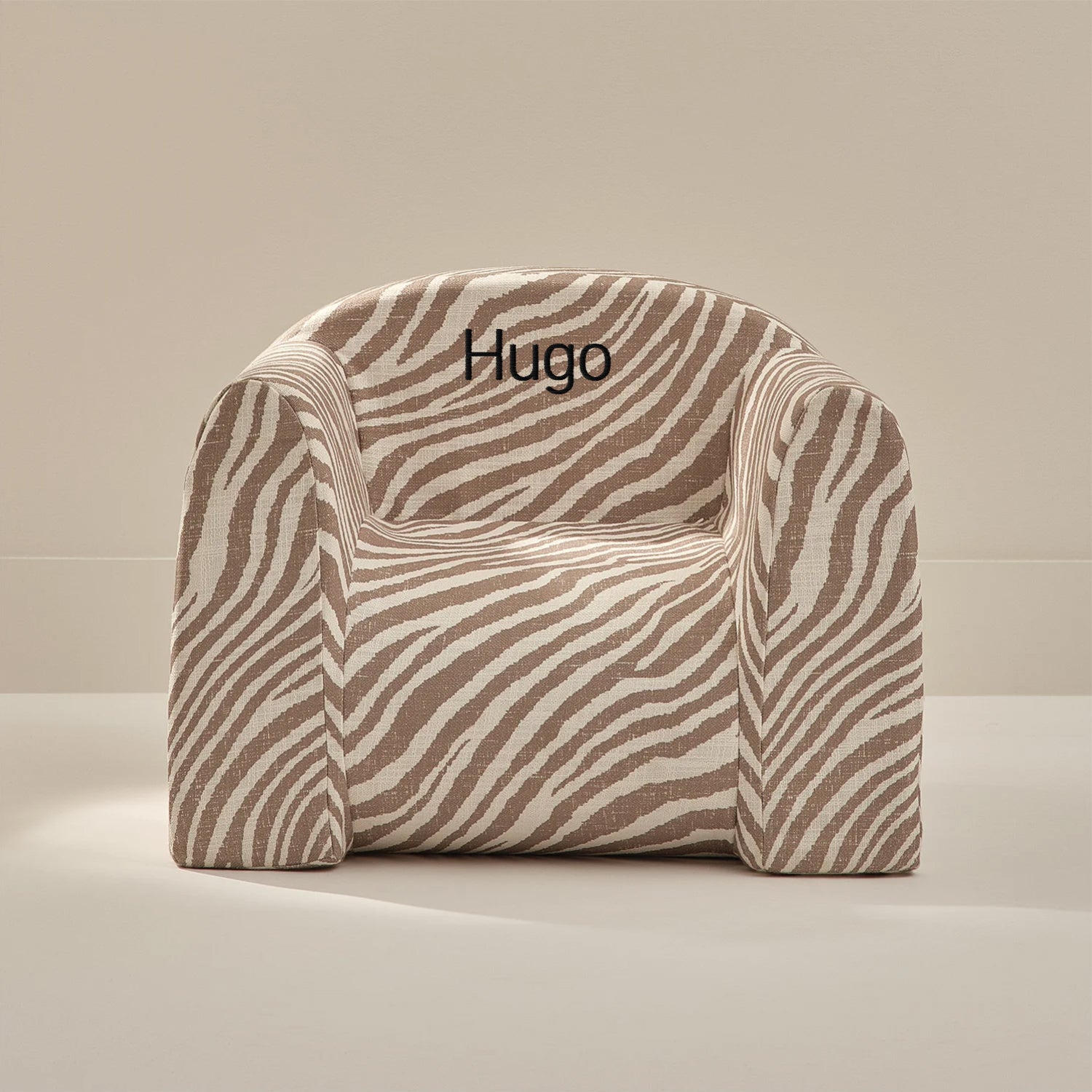 Zebra-patterned chair with 'Hugo' embroidery on a beige background