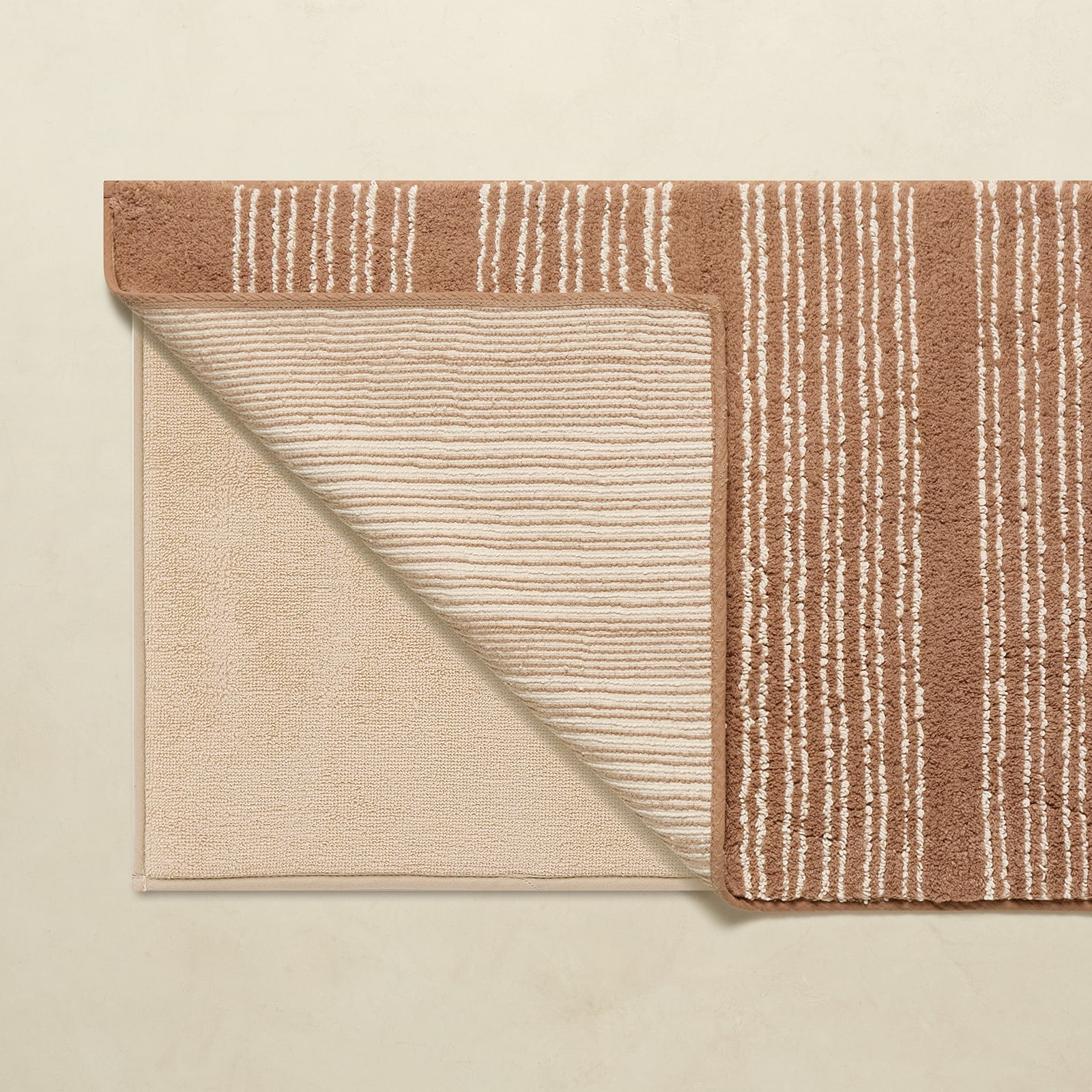Beige and brown striped rug on a beige background