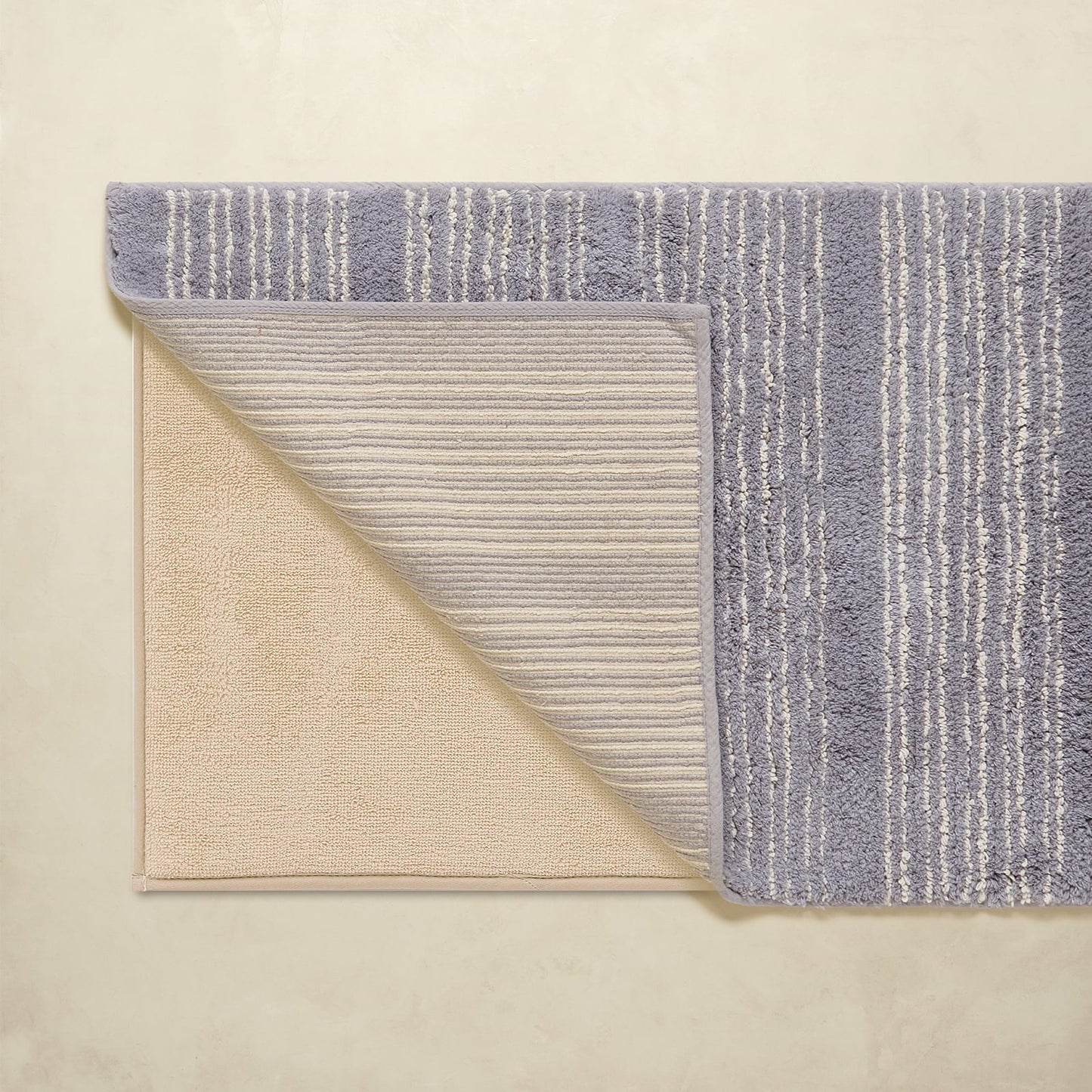 Two textured rugs with different patterns on a beige background