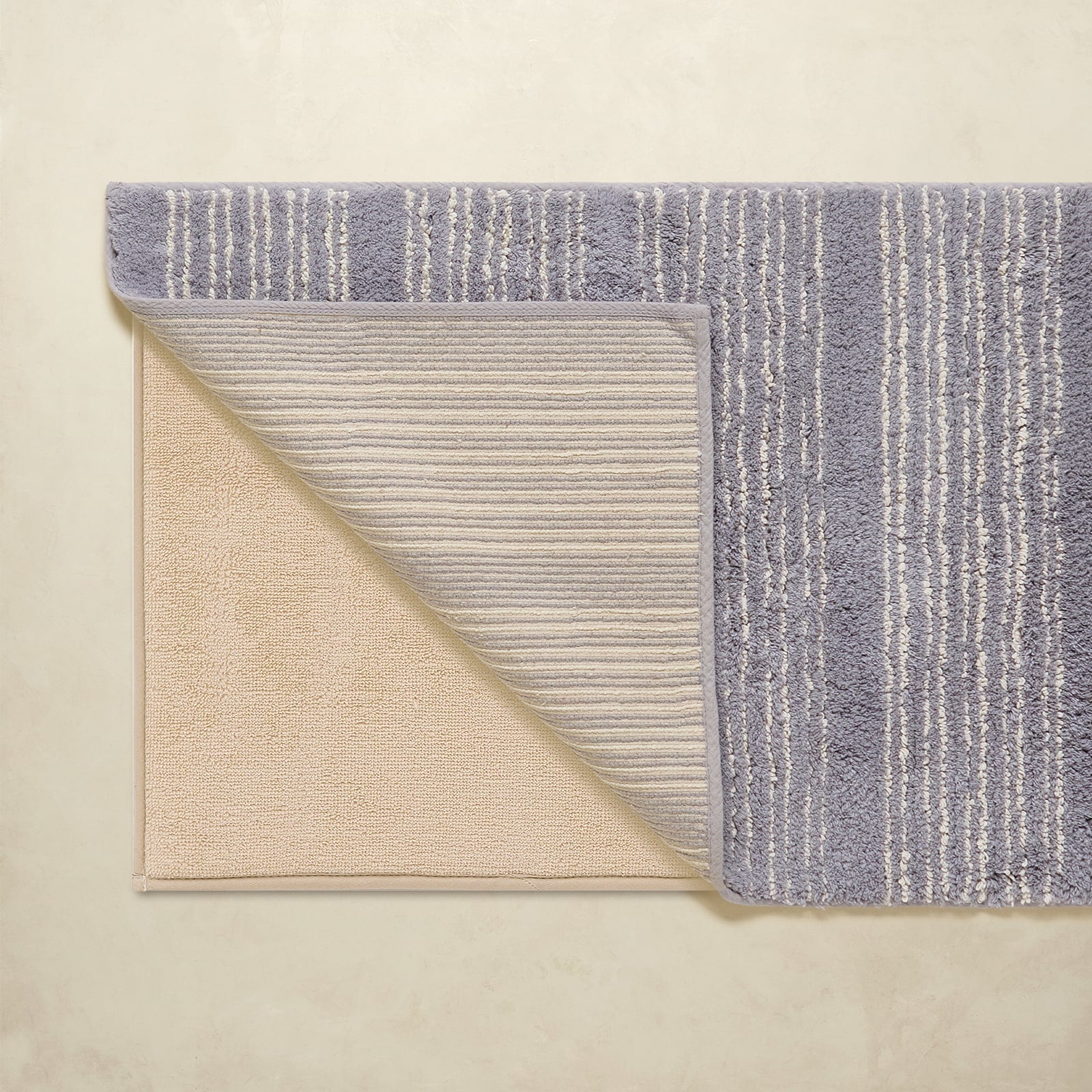 Two textured rugs with different patterns on a beige background