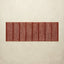 Rectangular red and white striped rug on a beige background