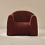 Red boucle armchair on a beige background