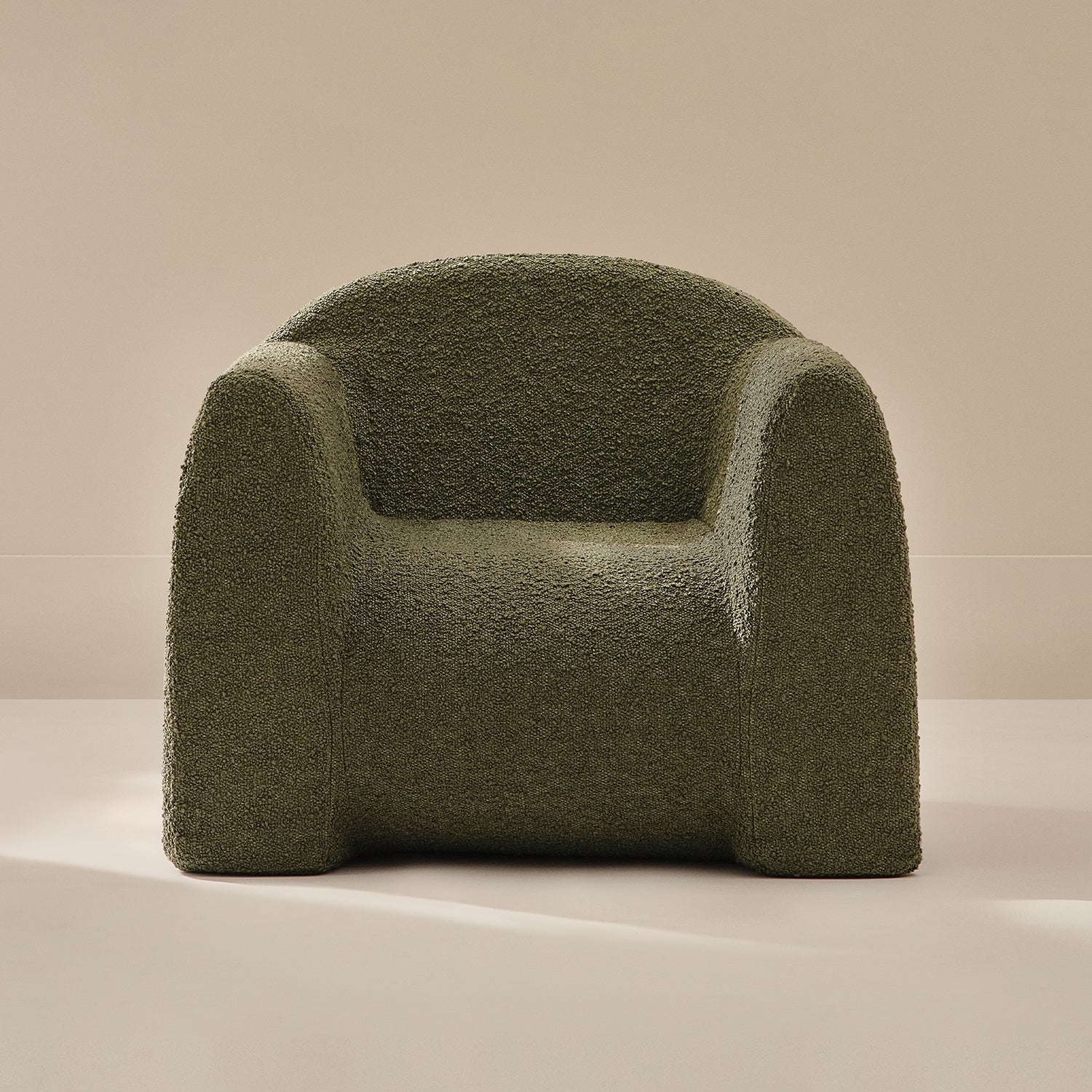 Green textured armchair on a beige background