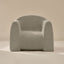 Light gray textured armchair on a beige background