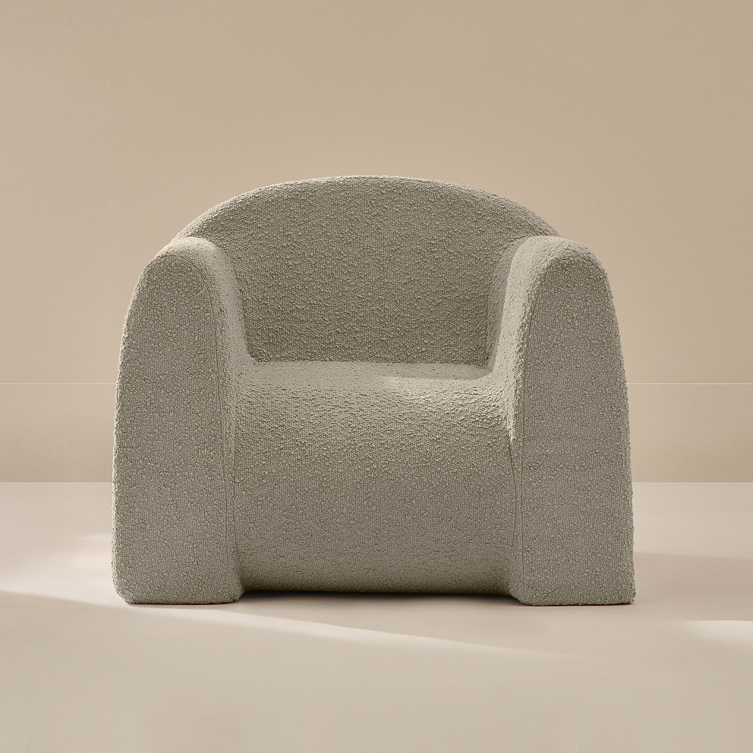 Light gray textured armchair on a beige background