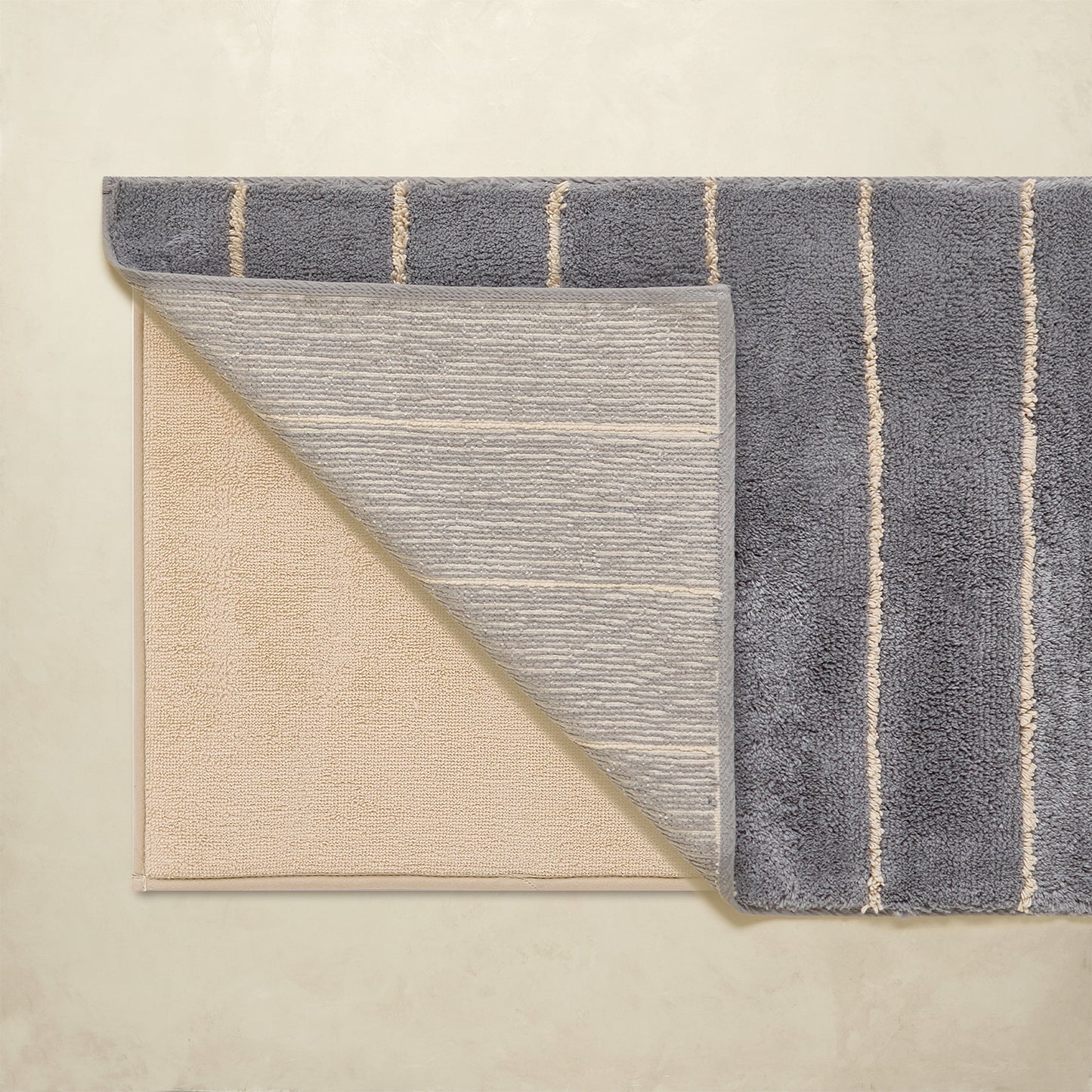 Two rugs with different patterns and colors on a beige background