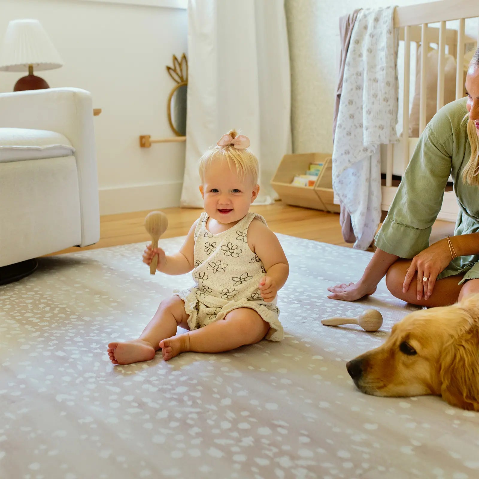 Fawn neutral beige animal print baby play mat shown in nursery with mom, dog, and baby playing with toys.