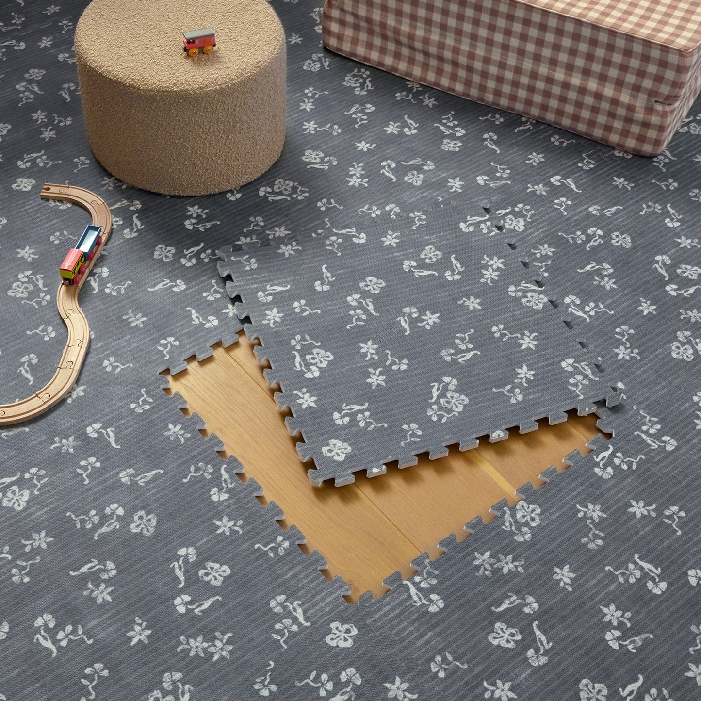 Children's play mat with puzzle tile expose with a floral pattern and wooden toys on top