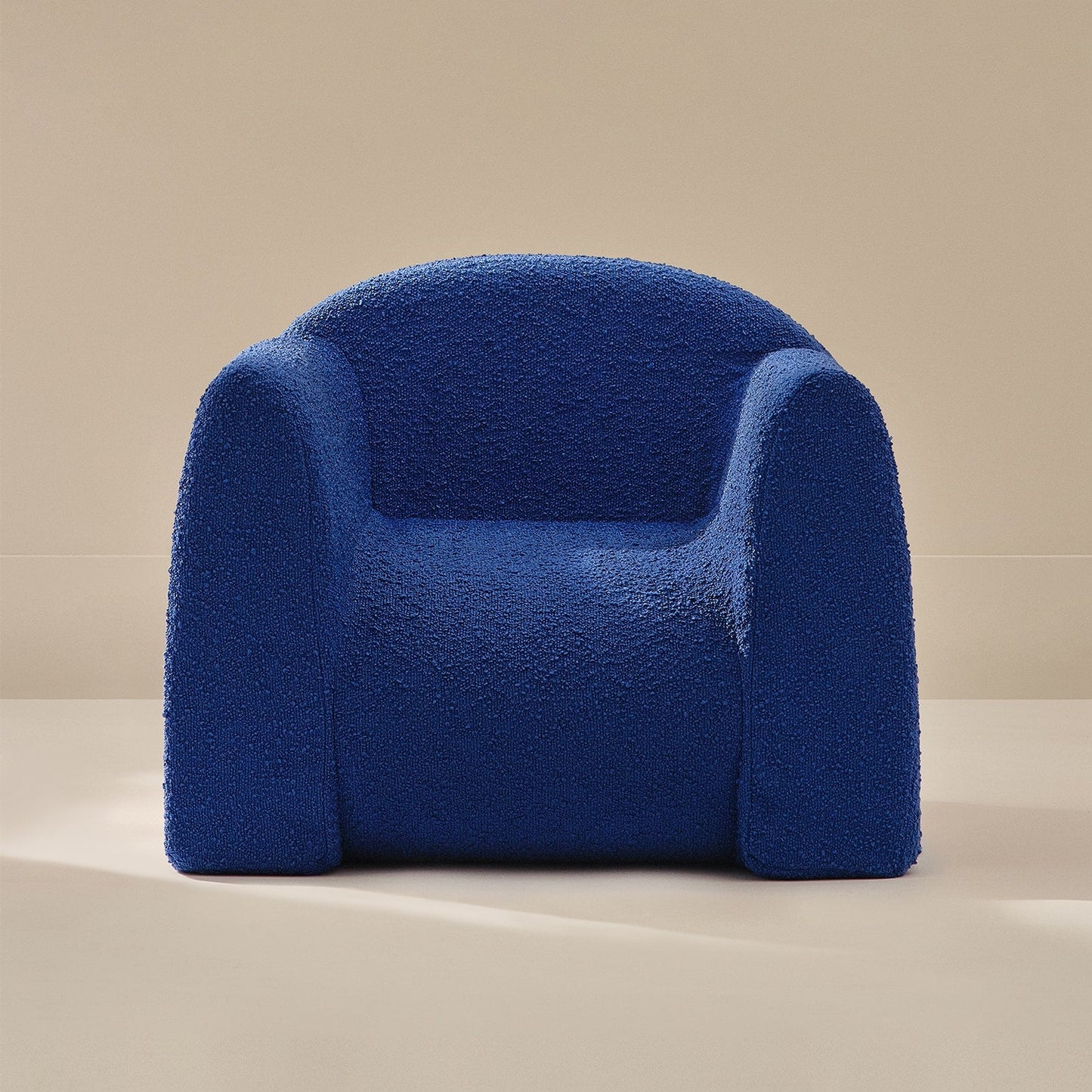 Blue textured armchair on a beige background