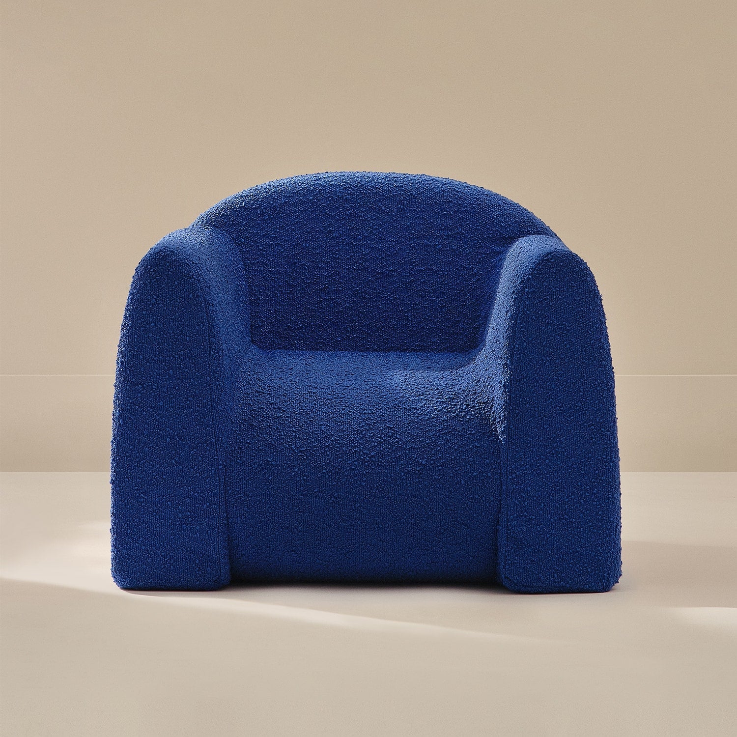 Blue textured armchair on a beige background