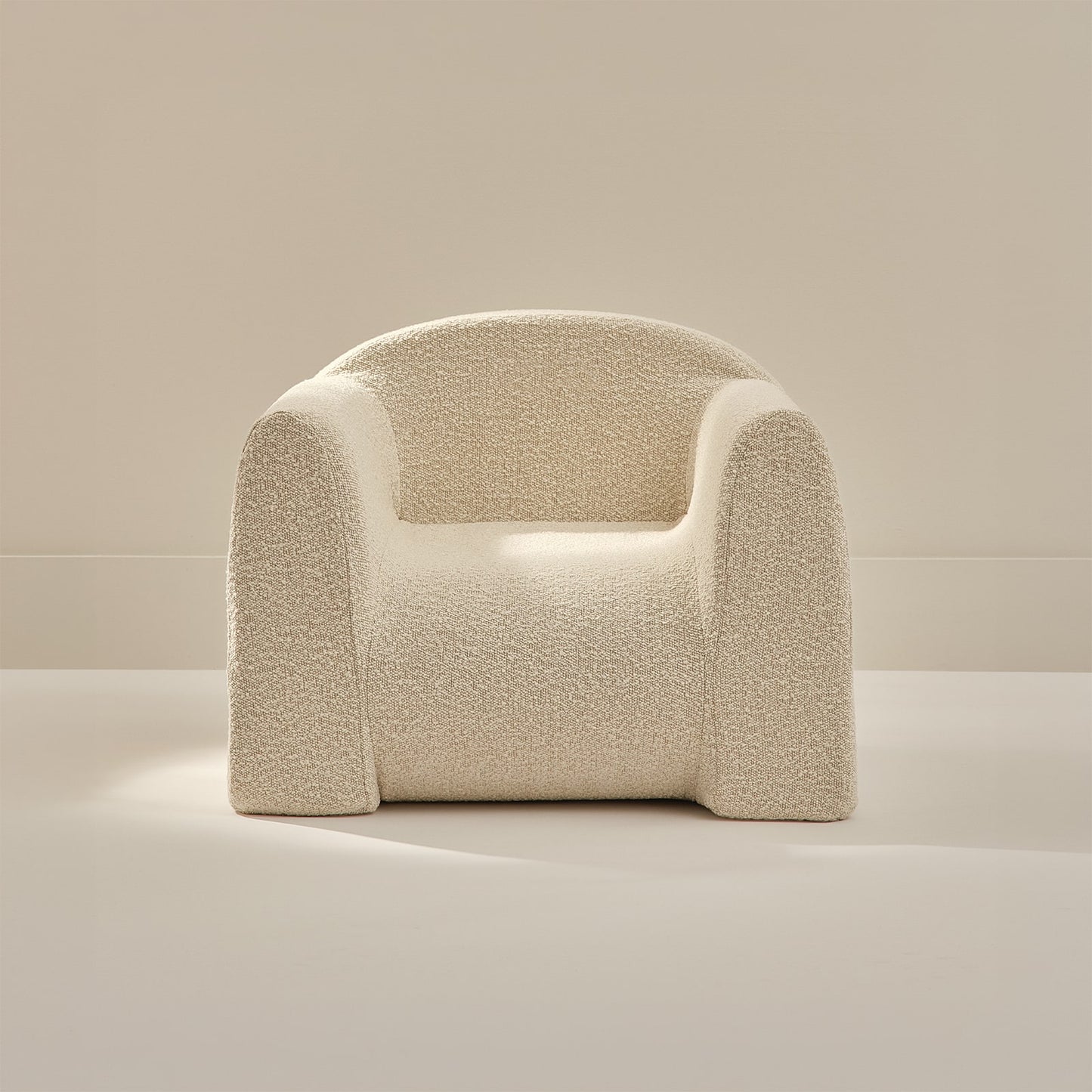 Beige textured armchair on a neutral background