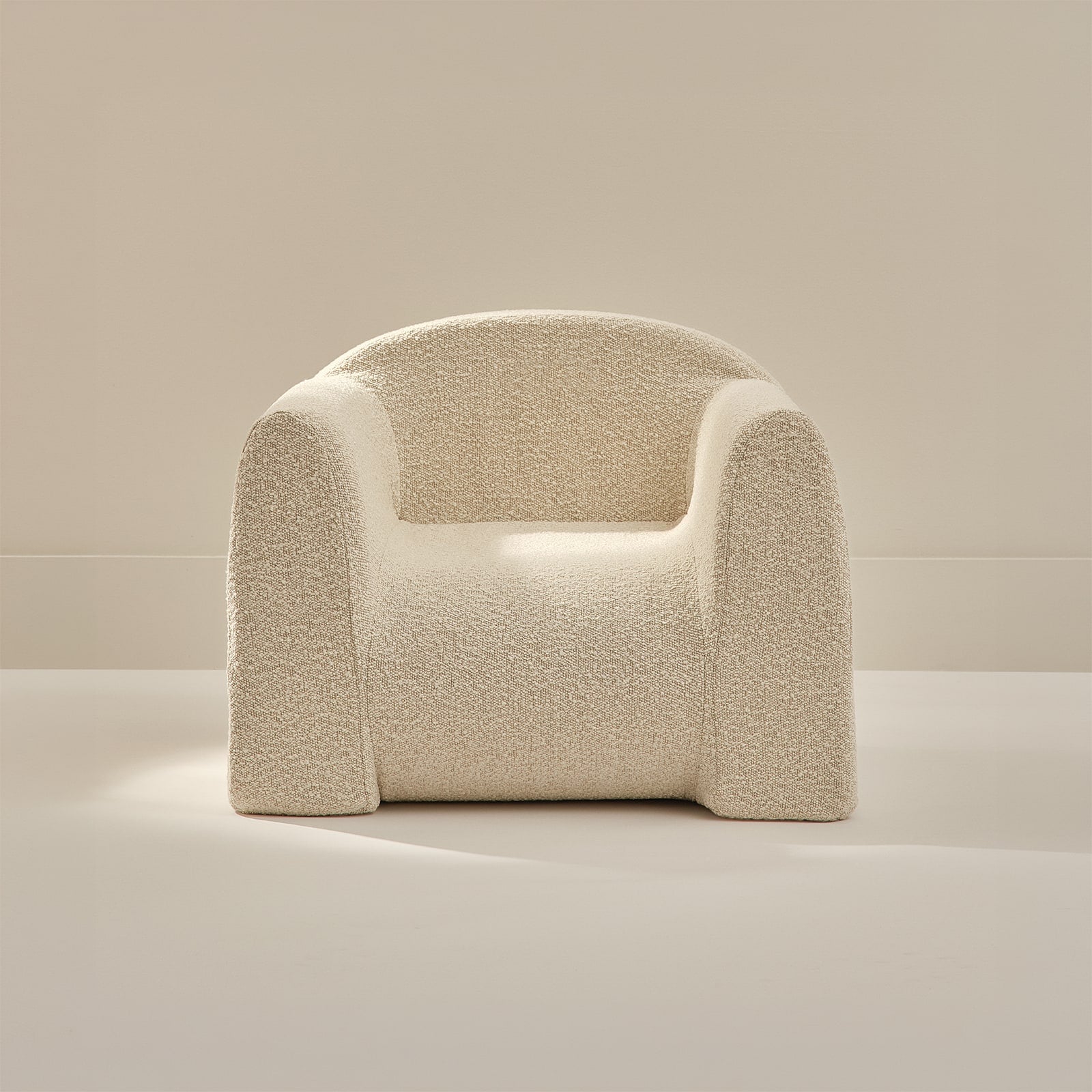 Beige textured armchair on a neutral background