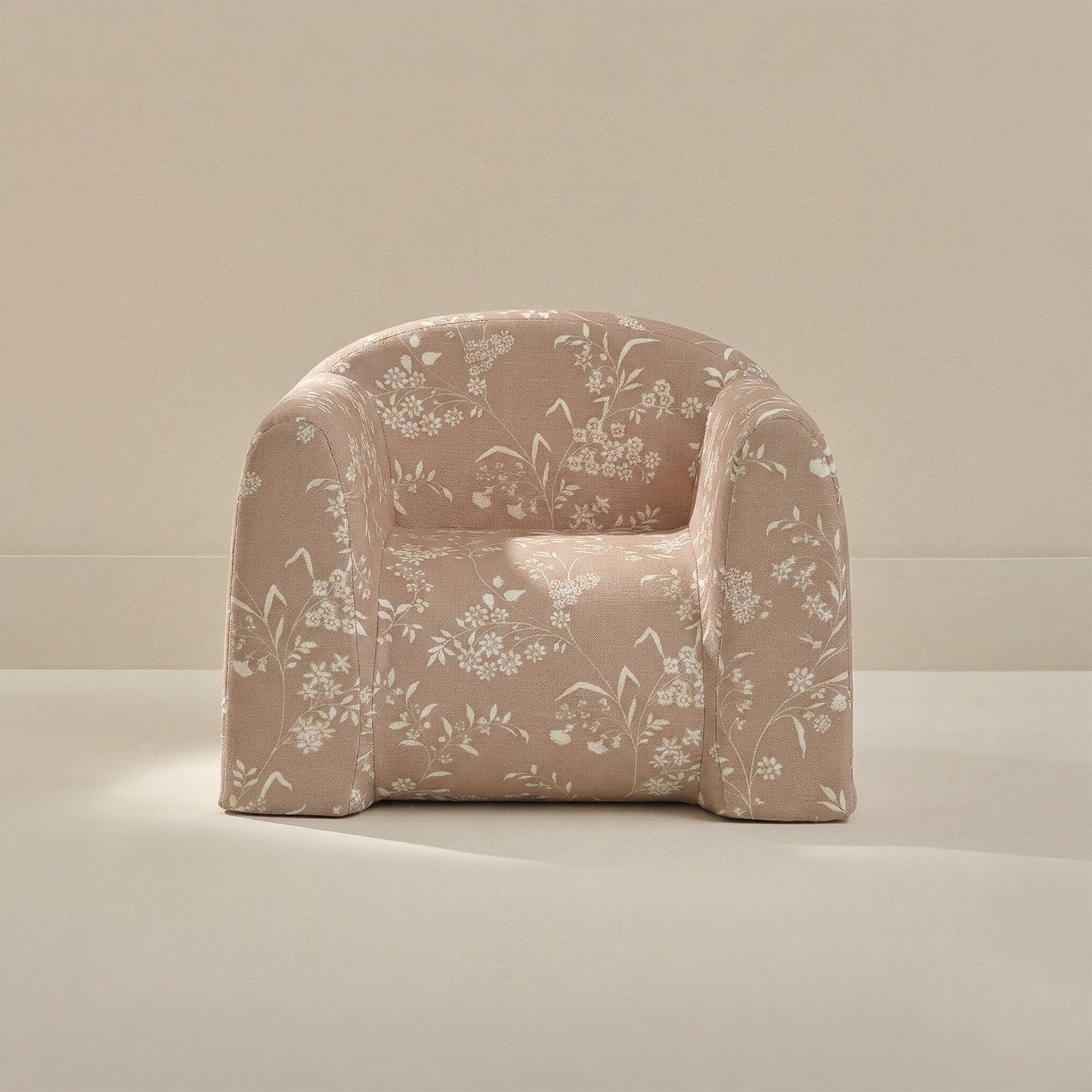 Floral-patterned armchair on a neutral background
