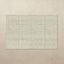 Rectangular tumbling mat with a subtle pattern on a beige background