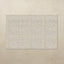 Rectangular tumbling mat with a subtle pattern on a beige floor