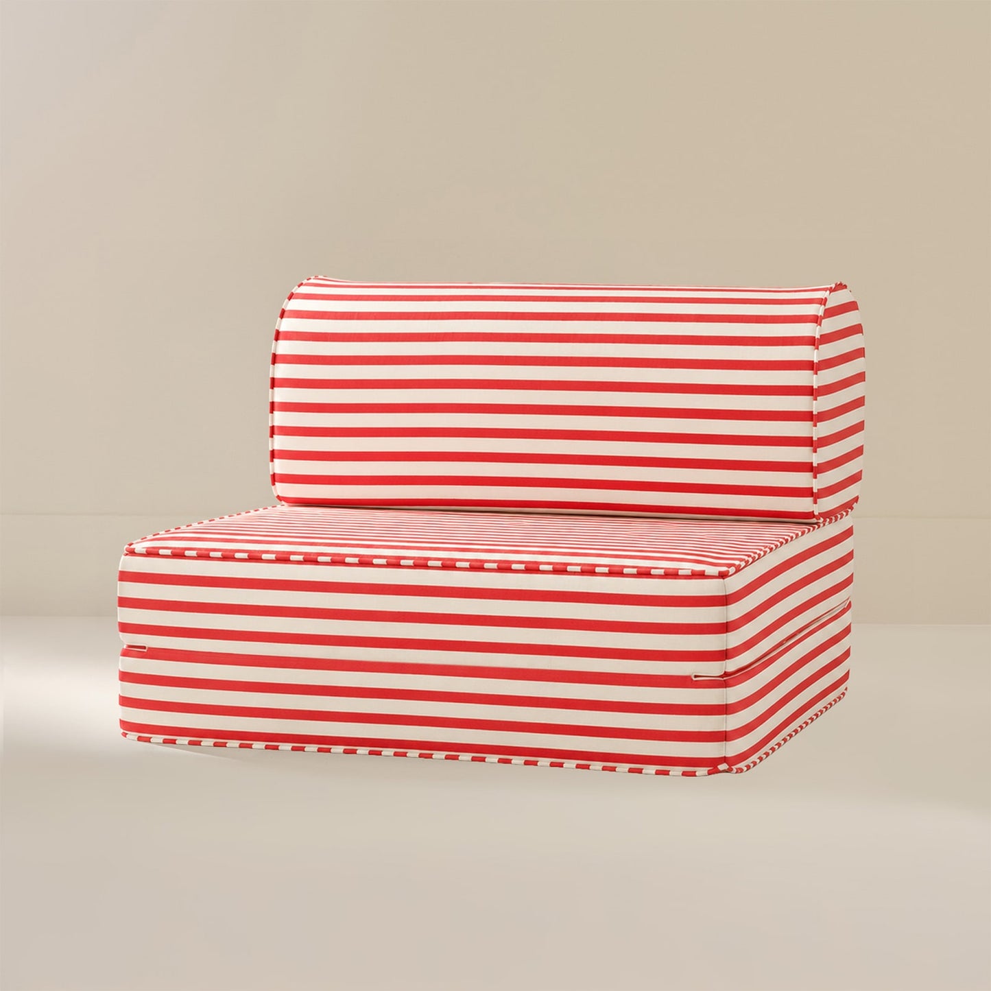 A red and white striped seat, set against a plain beige studio background.