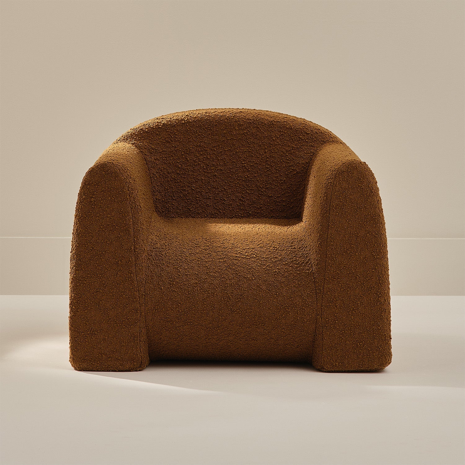 Brown boucle armchair on a neutral background
