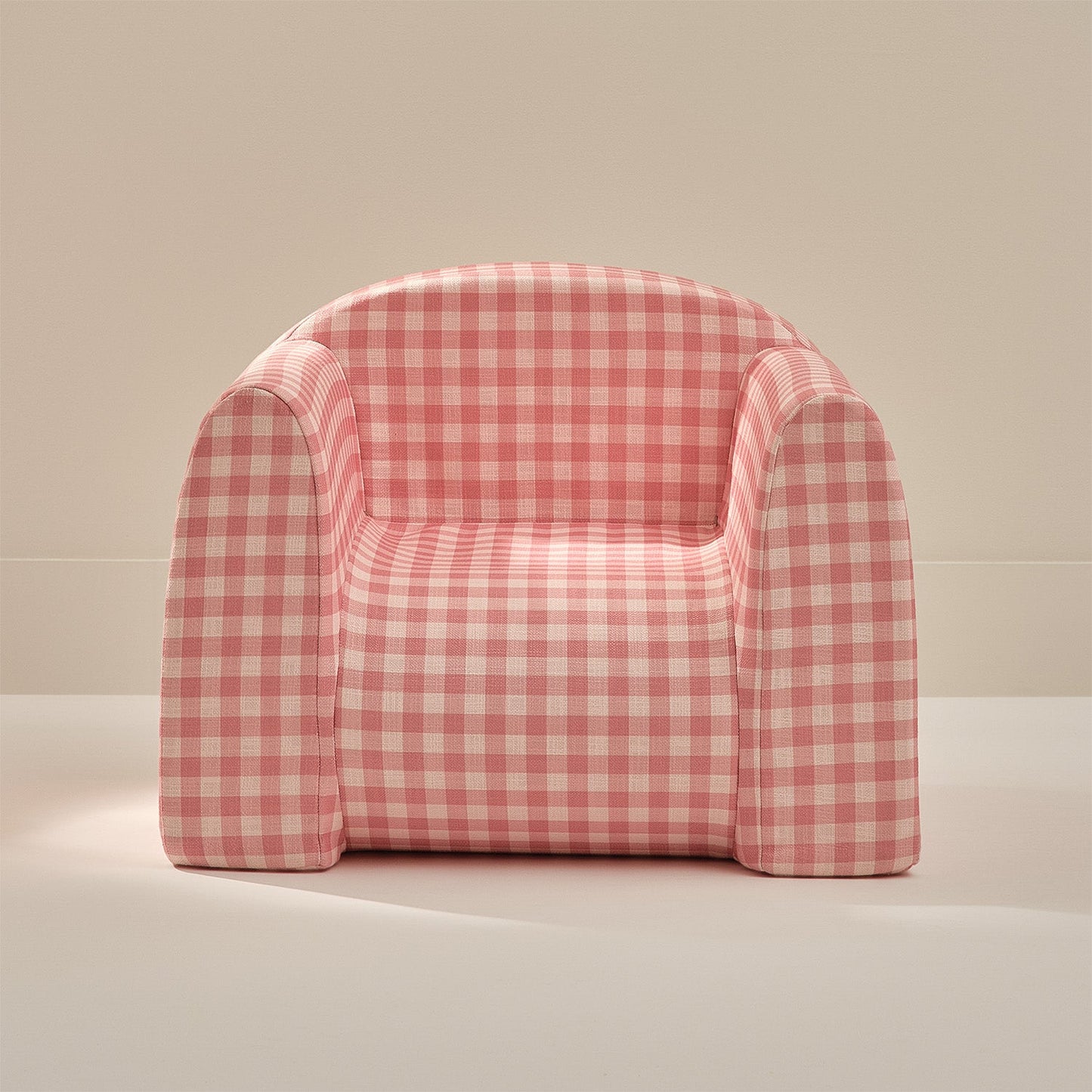 Pink and white checkered chair on a beige background