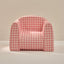 Pink and white checkered chair on a beige background